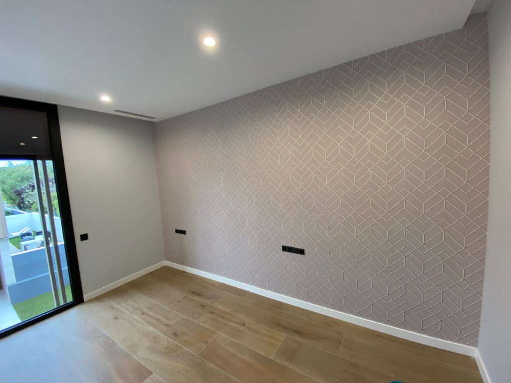 Habitación con papel pintado con color beige en Burriana.